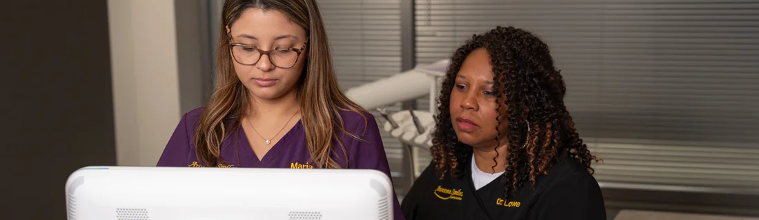 Dr. Tontra Lowe working at a computer.