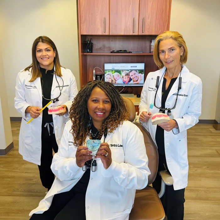 Dentists Tontra Lowe, Emoke Basa, and Karen Saavedra-Chavez all holding tooth models